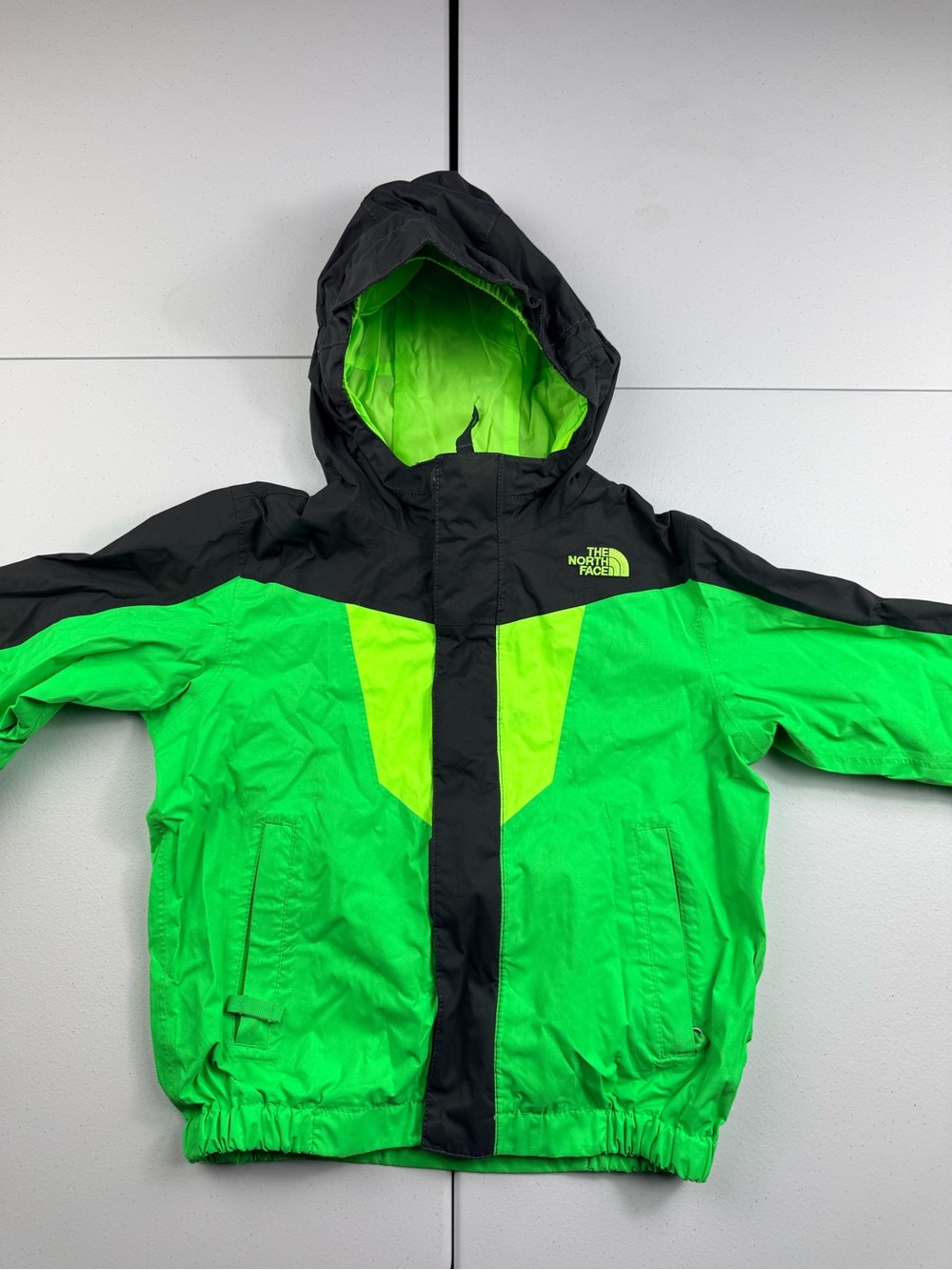 The North Face Kids Black and Bright Green Hooded Rain Jacket